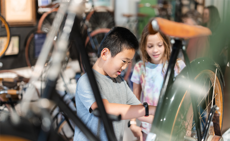 Young boy and girl looking at a bicycle at the Bicycle Museum of America in New Bremen Ohio