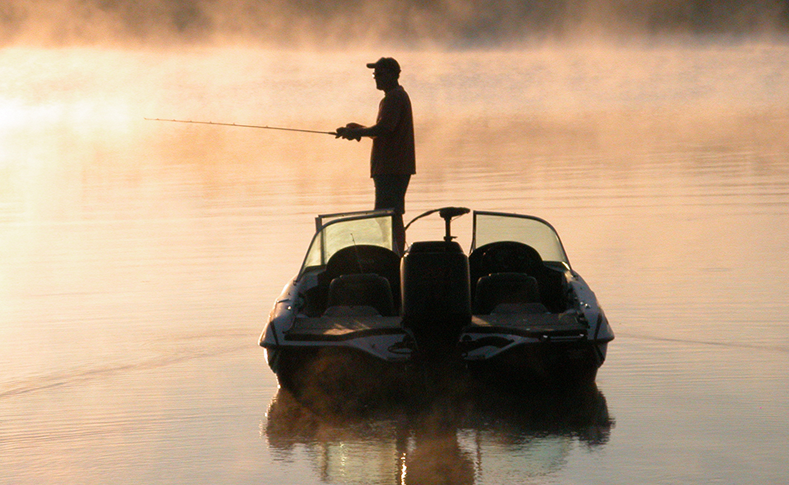 Man standing on a boat fishing on Grand Lake St Marys in Ohio