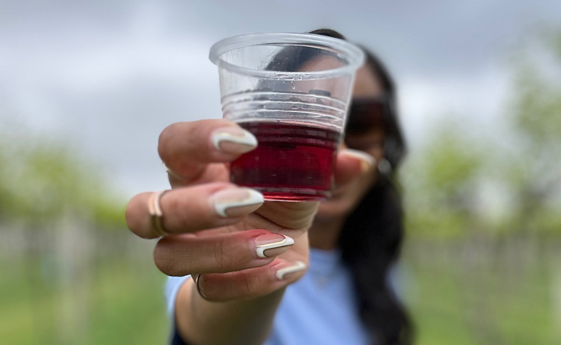 Woman holding a taste of wine at a winery in Ohio's Grand Lake Region