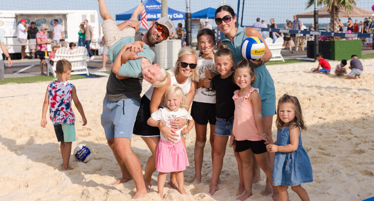 Family posing on a sand volleyball court in Celina Ohio