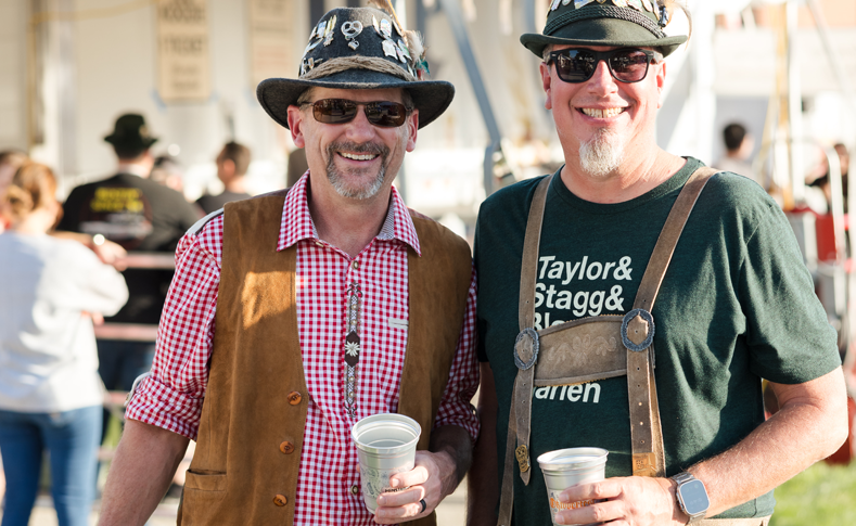 Two men holding beer at Oktoberfest in Minster Ohio