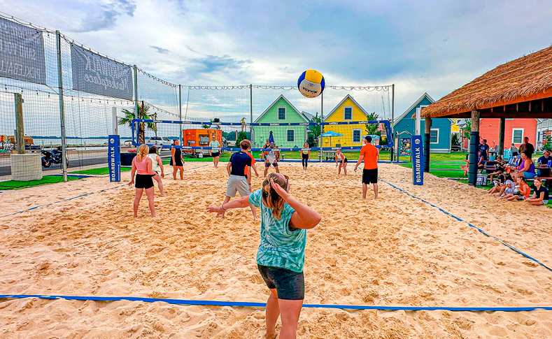 People playing sand volleyball at Boardwalk Marketplace in Celina, Ohio