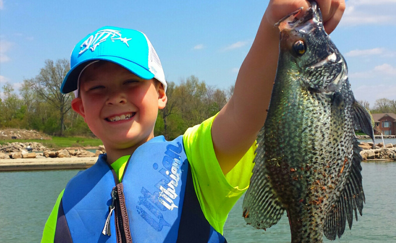 Boy holding up a bluegill caught at Grand Lake St Marys in Celina Ohio