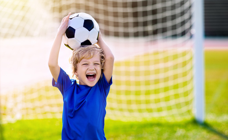 Kid holding a soccer ball on his head in St Marys Ohio
